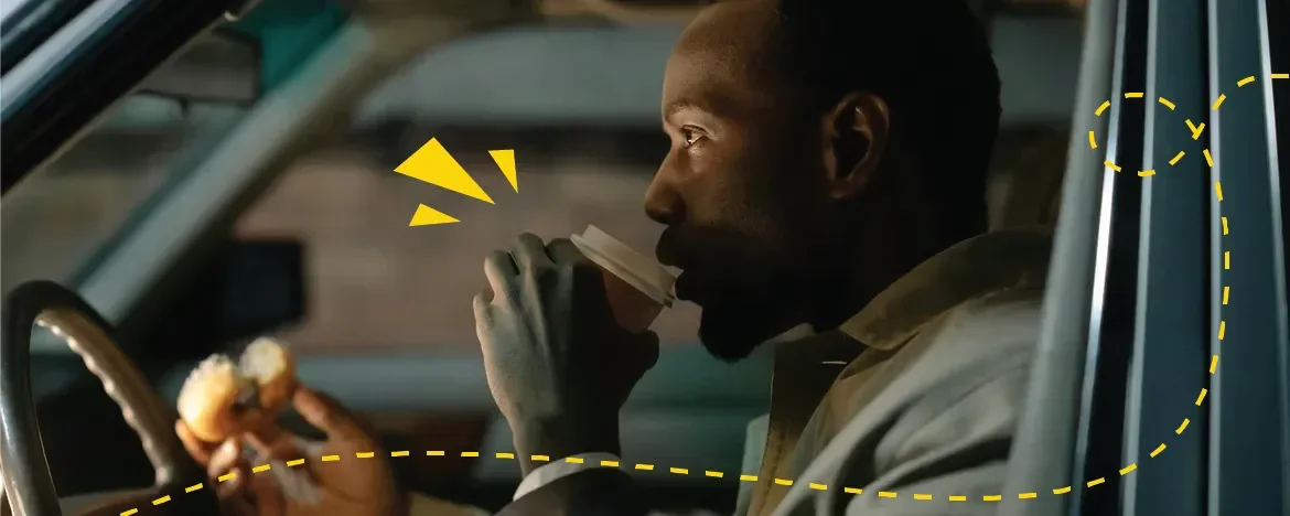 person drinking in car