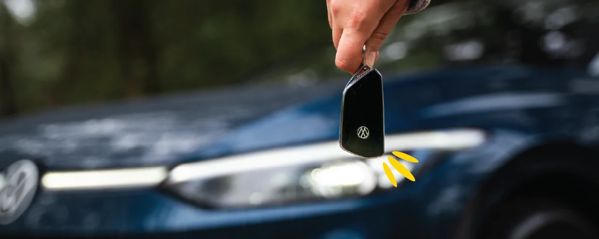 Hand holding a key in front of VW ID.5