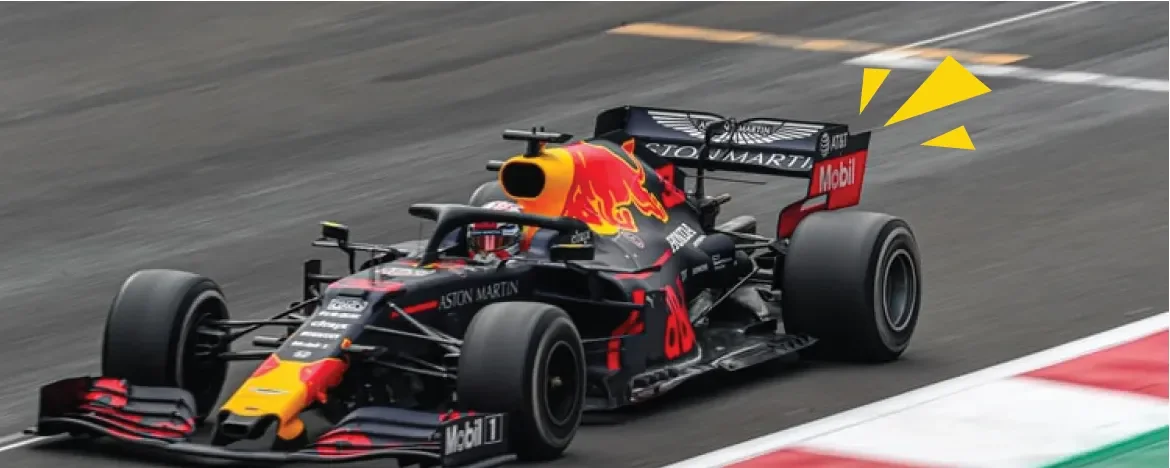 Black and orange racing car in motion