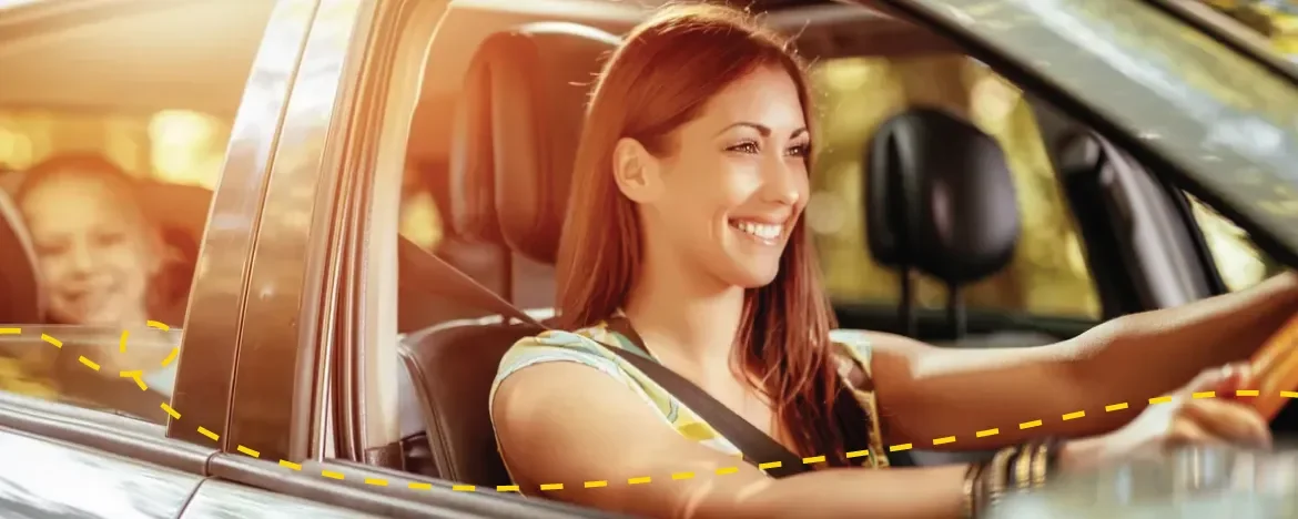 woman driving with child in the back