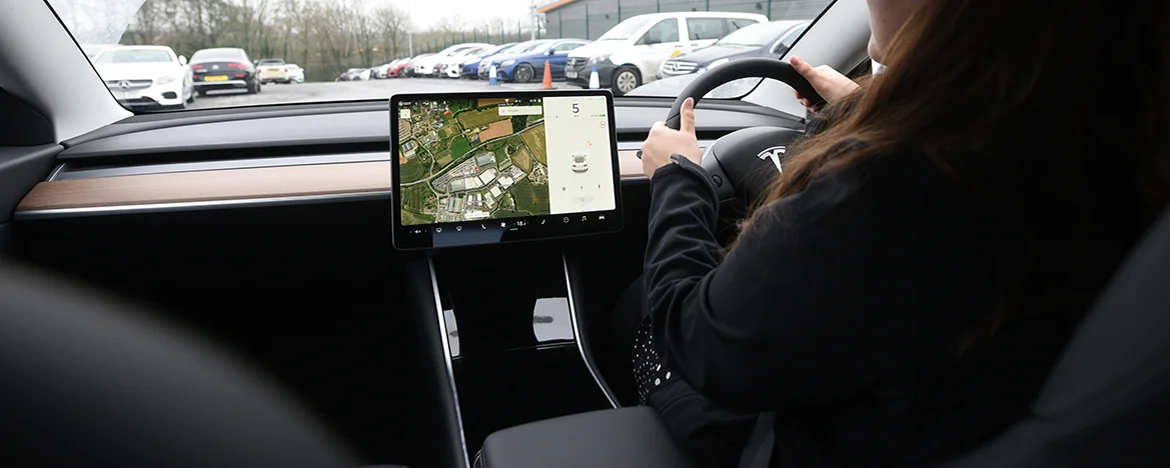Woman driving Tesla Model 3 