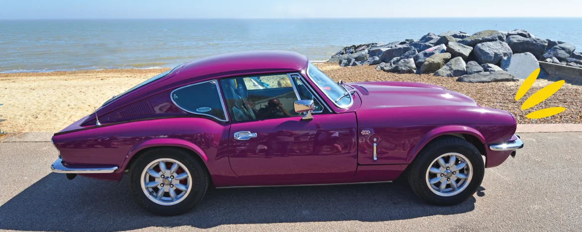 Triumph GT6 Mark III in Magenta parked up at the seafront