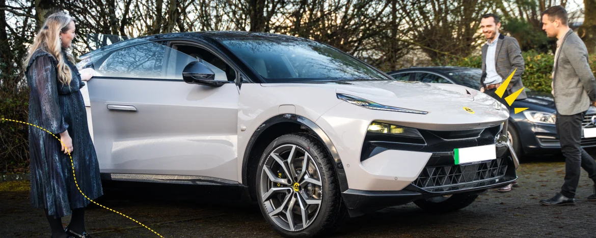 Carparison leadership inspecting a new Lotus Eletre