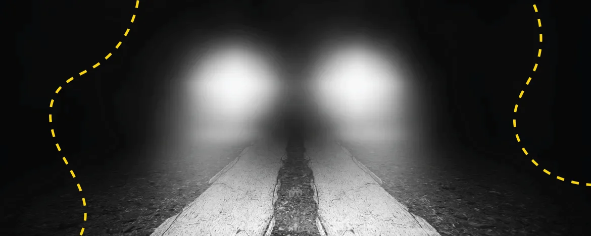 Dark road with nothing but car headlights showing