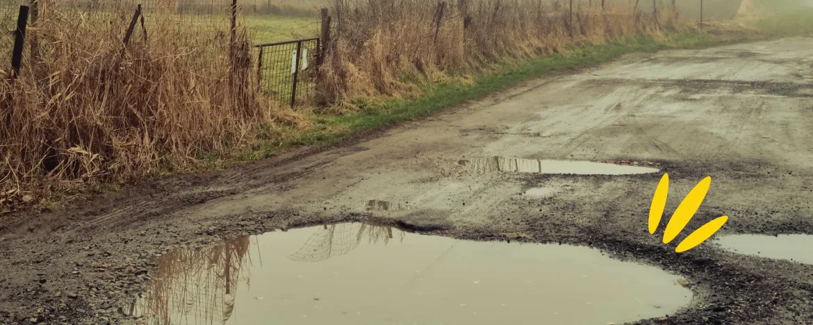 A country road with pot holes