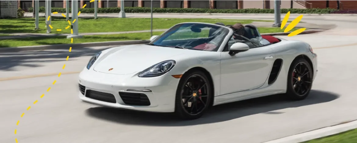 Porsche Boxster driving on road