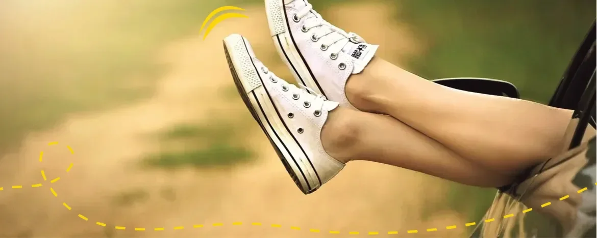 feet out car window with shoes on