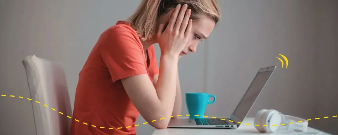 Person looking at laptop with head in hands