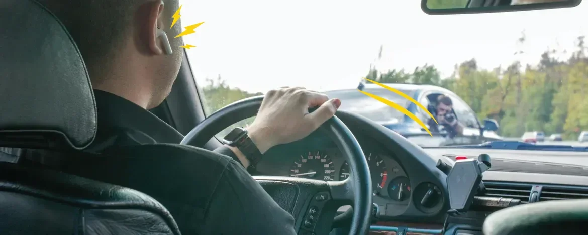 person with headphones while driving