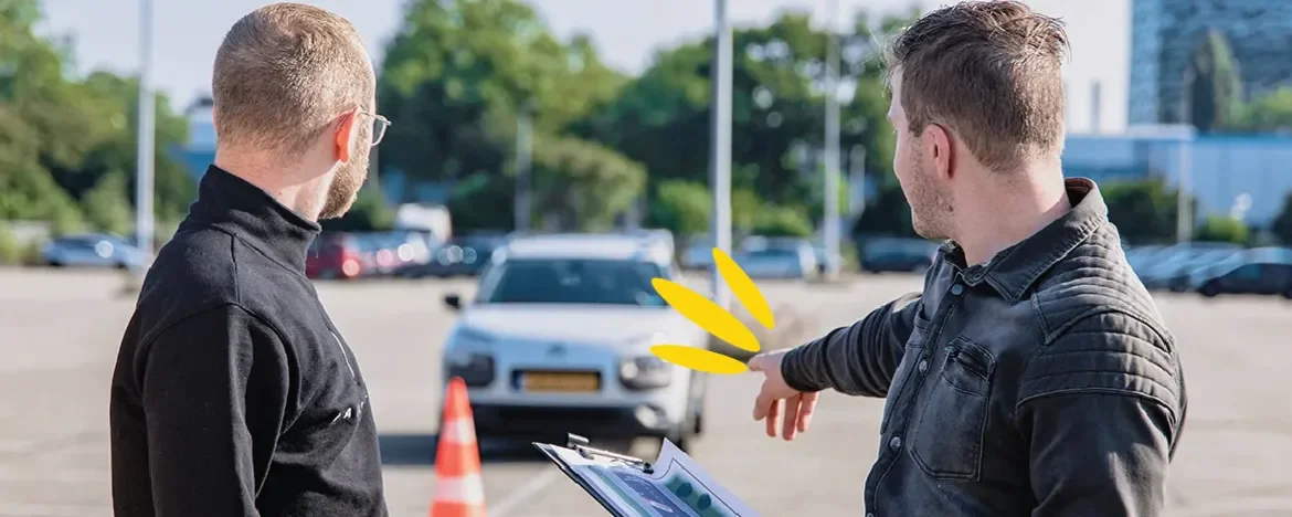 Driving instructor explaining something to his student