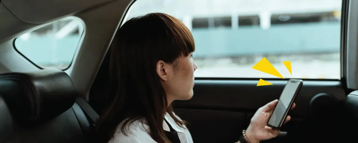 Person in car with mobile phone