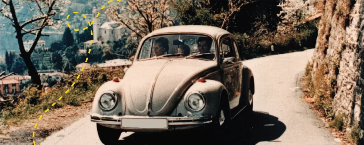 Original VW Beetle driving through the mountains