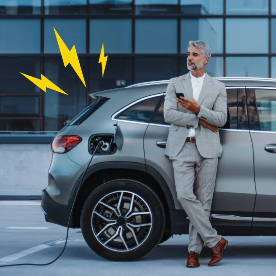 Man stood next to car charging