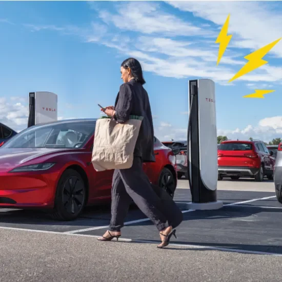 Woman infront of tesla supercharger