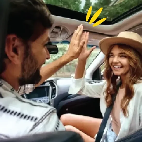People high-fiving in car