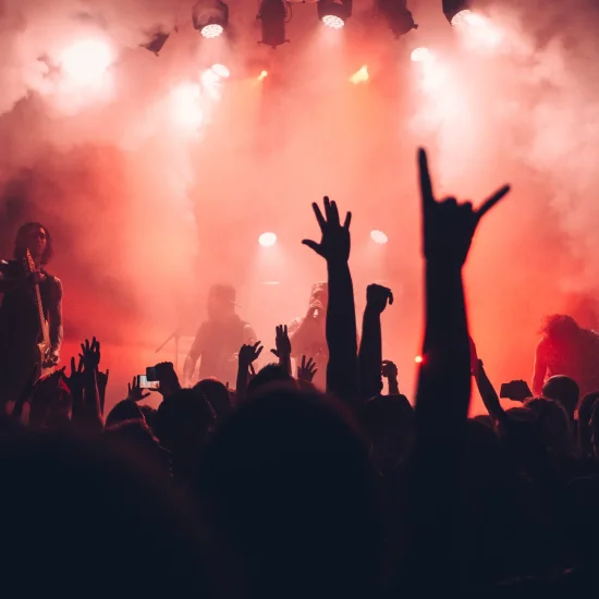 A large crowd watching a band on stage