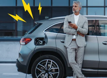 Man stood next to car charging
